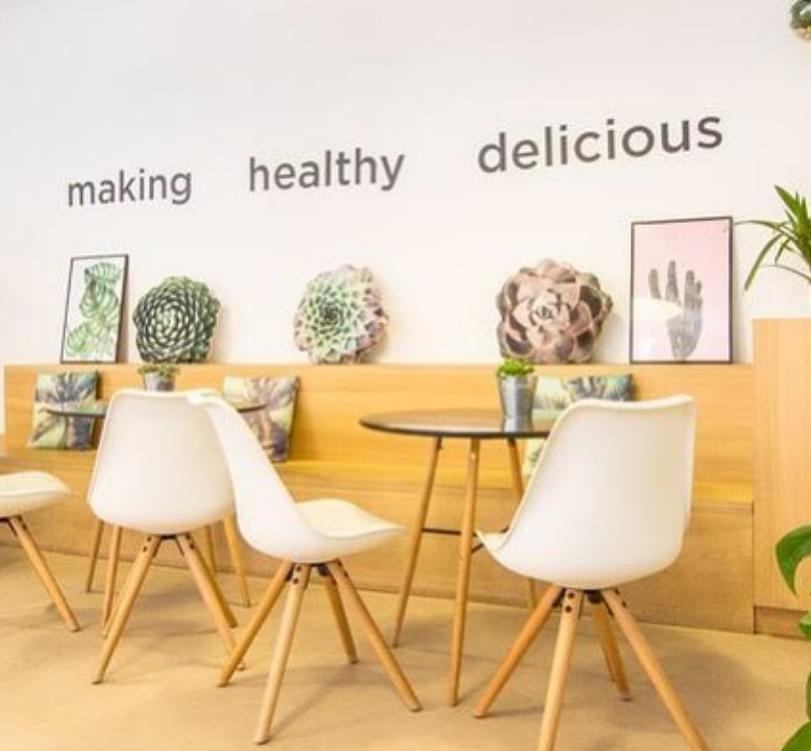 Juice by Nature store wall reading making healthy delicious.